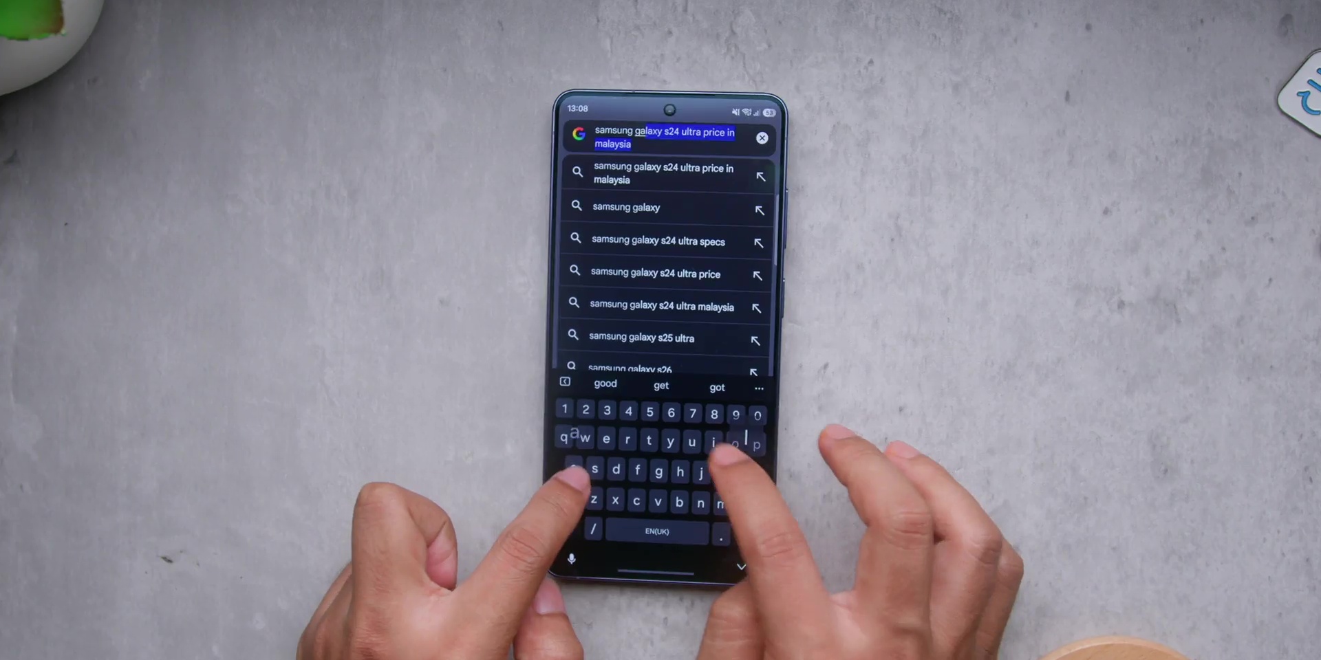 Typing on the Galaxy S26 Ultra display while resting on a flat surface.