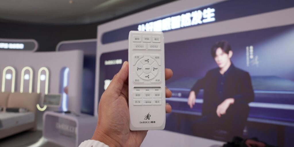 Close-up of the remote control for the DeRucci smart mattress system.