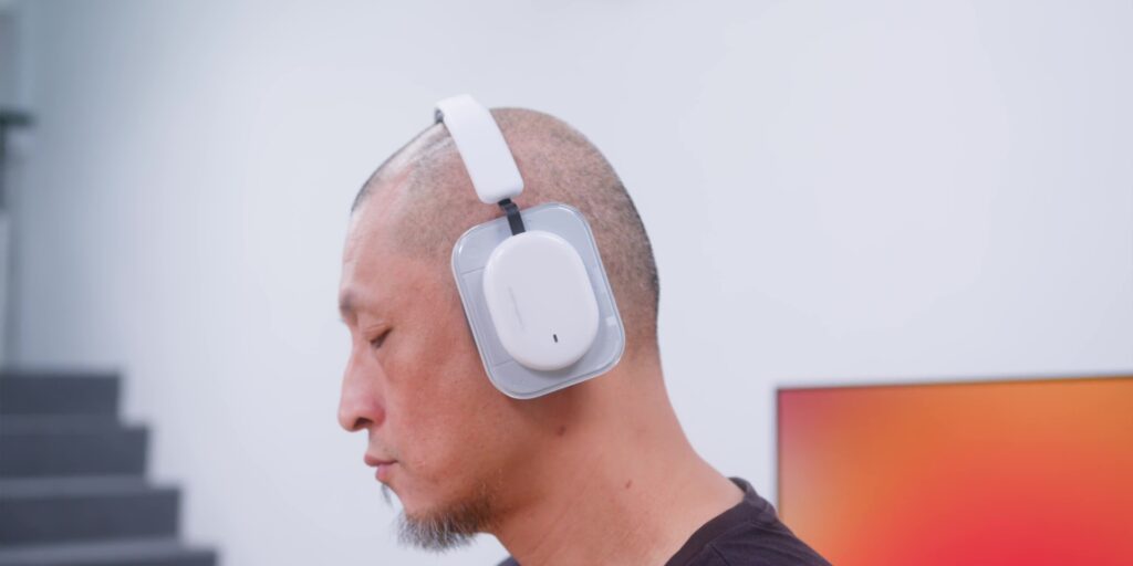 A person wearing the Nothing Headphone a, representing the audio engineering and soundstage of the headphones.